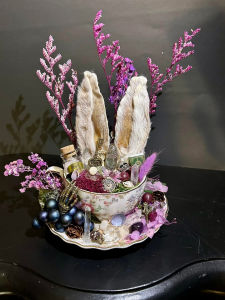 Haunting deer antler display with bone carvings and antique lockets, whispering tales of the past.